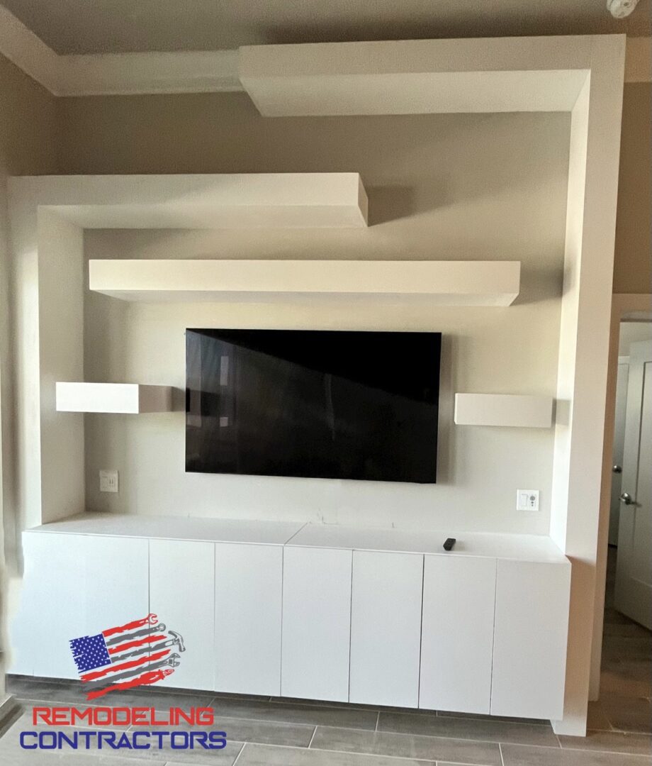 An inside of a modern house with a tv mounted in the wall